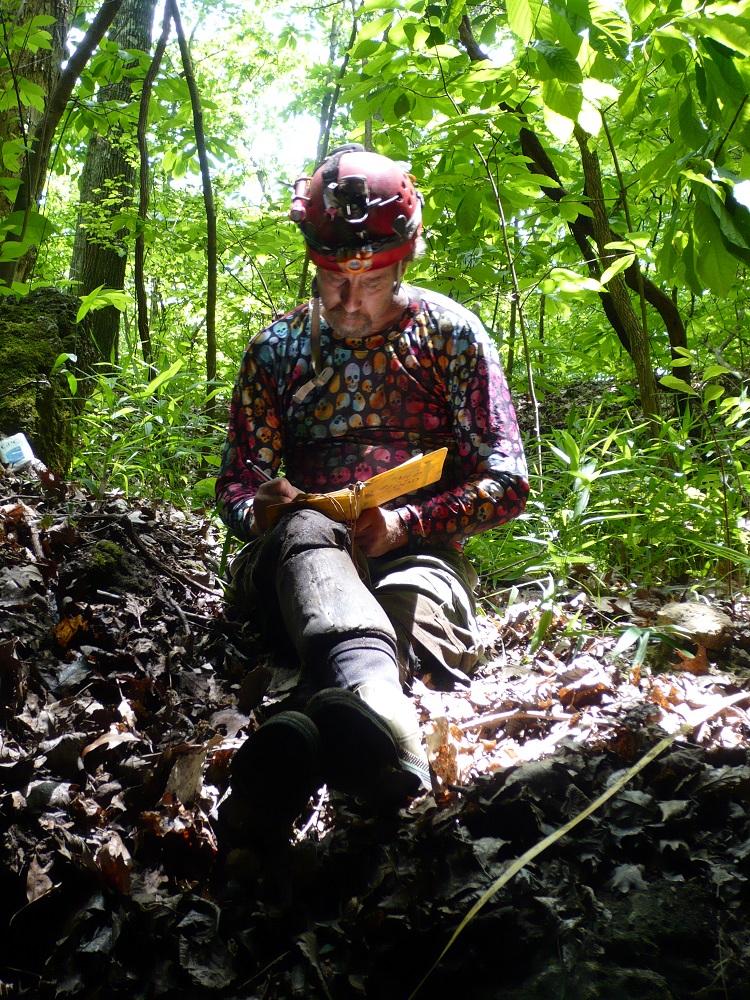 researcher making notes in forest